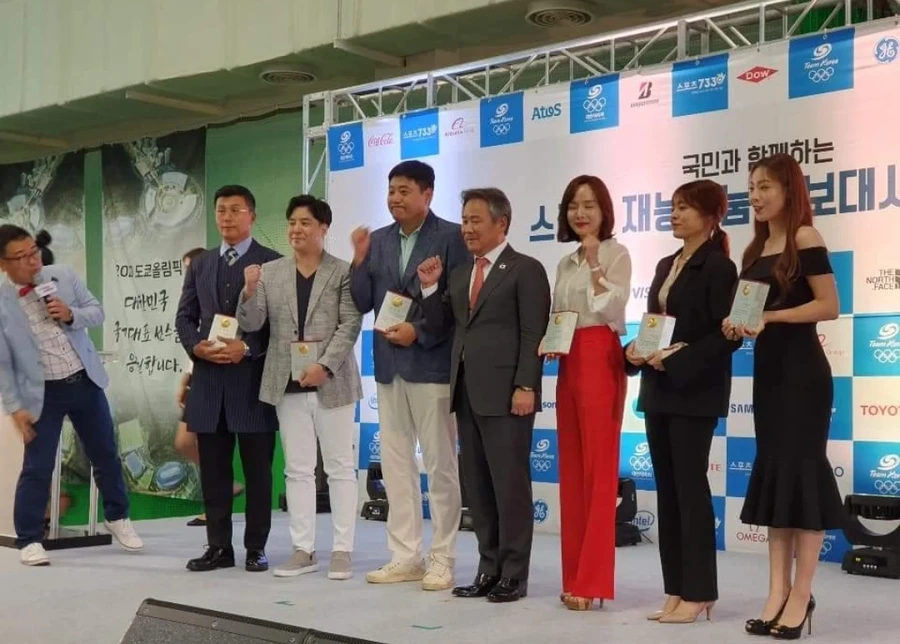 무대 위에서 위촉패를 들고 포즈를 취하는 참석자 단체